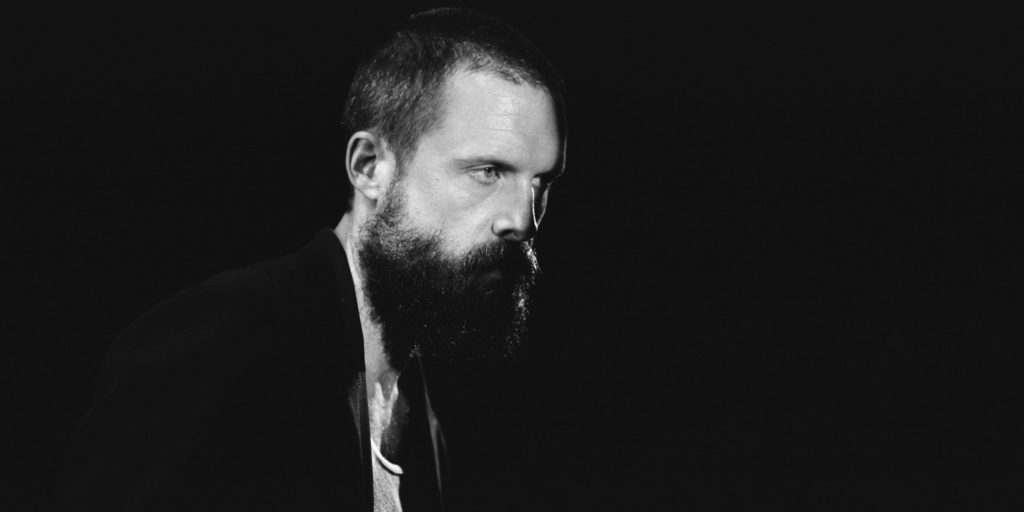 Black and white photo of Father John Mister side profile.